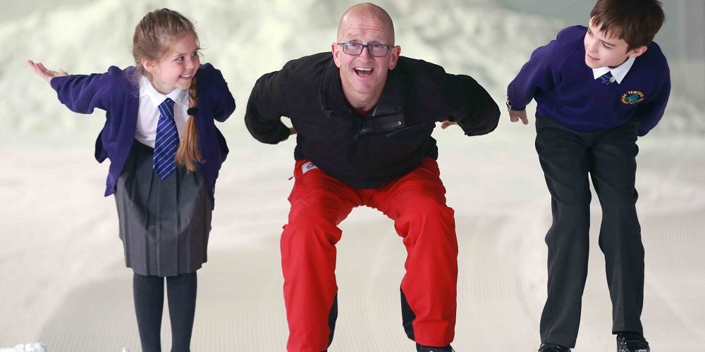 National Schools Snowsport Week ambassador Eddie the Eagle with Patrisia TJ from Yewtree Primary School Hemel Hempstead