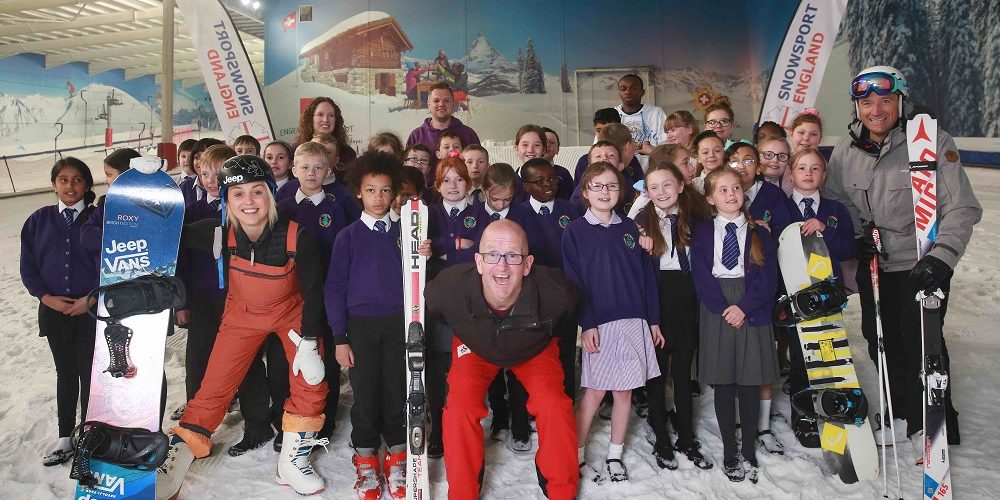 National Schools Snowsport Week ambassadors Aimee Fuller Eddie the Eagle and Graham Bell with schoolchildren from Yewtree School Hemel Hempstead